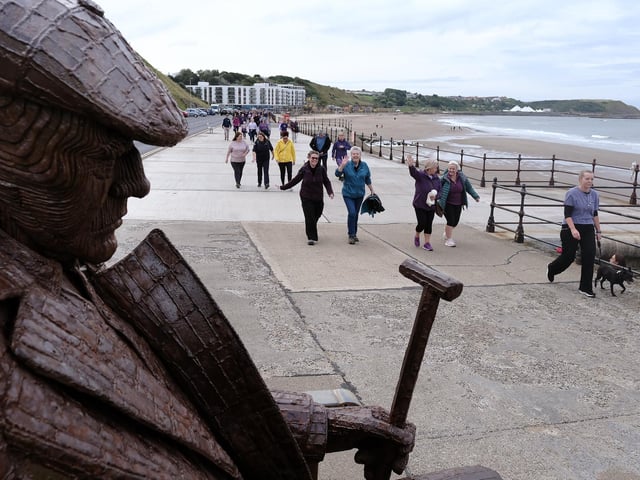 Walkers passing the Freddie Gilroy statue.
picture: Richard Ponter