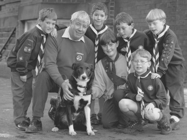 Hugh Donnolly and Tyke the Superdog meet the Scouts and Guides at their fundriasing event at Westborough Methodist Church in November, 1995. Pictured from left are Michael Parker, Christopher Jones, Hugh and Tyke, Stuart Parker, Tim Slade; front, Clair Parker and Theo Slade. 