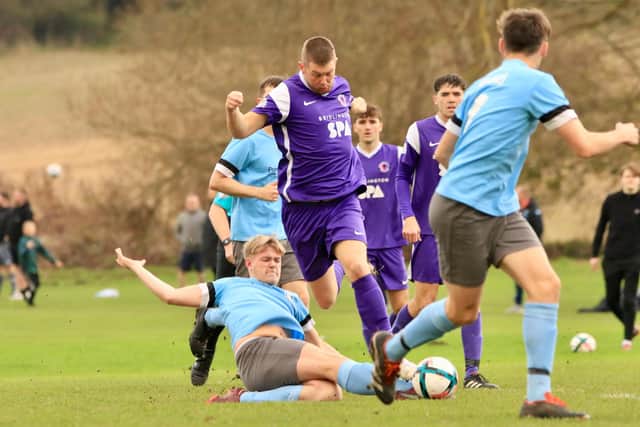 Brid Rovers Reserves, blue kit, slide in to take the ball away from Brid Spa. Photos by TCF photography