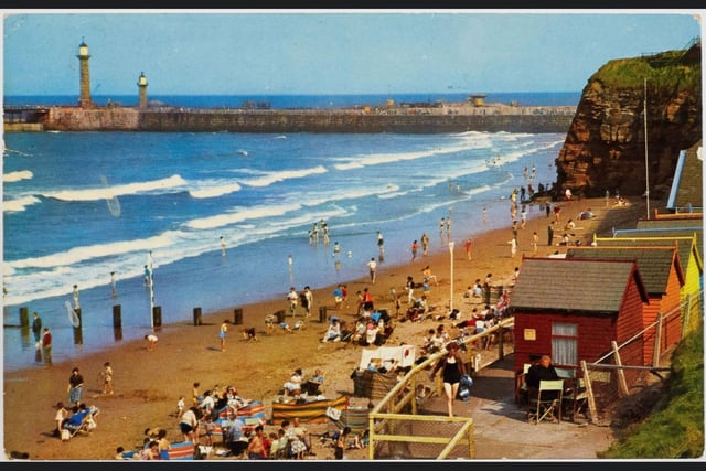 A colour postcard showing the beach at Whitby, circa 1960s to 1970s.