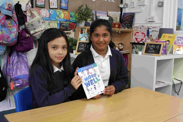 Pupils from Morley Victoria School reading the book Move Well.