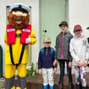 Stormy Stan, the RNLI's mascot and volunteer crew member Harry Grantham pose for photographs with visitors to Staithes.picture: RNLI/Helen Grantham