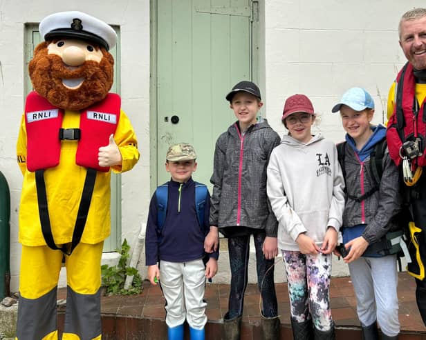 Stormy Stan, the RNLI's mascot and volunteer crew member Harry Grantham pose for photographs with visitors to Staithes.picture: RNLI/Helen Grantham