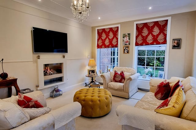 Natural light floods in to this reception room with feature fireplace.