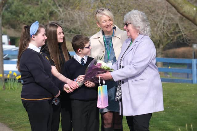 St Augustine's School pupils with Sarena Everall present Judith McCulloch with flowers to say thank you for 48 years of dedicated service