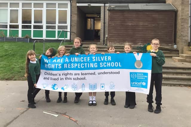 Youngsters at Whitby's Airy Hill School with the UNICEF accreditation banner.
