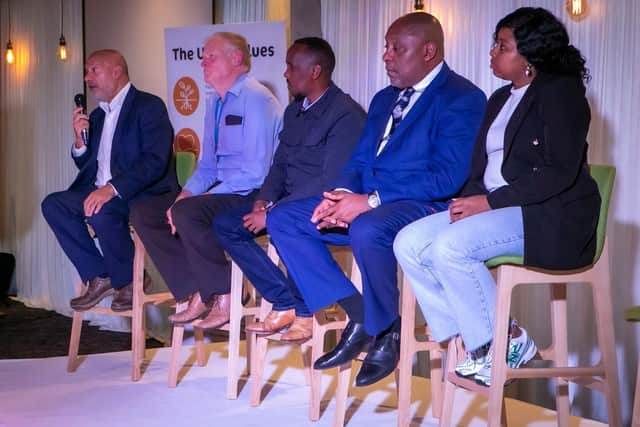 Former Unity Homes and Enterprise chief executive Ali Akbor OBE (left) addressing its Annual General Meeting, alongside Phil Cole, Jamal Tahlil, Patrick Bernard and Saskia Fishley