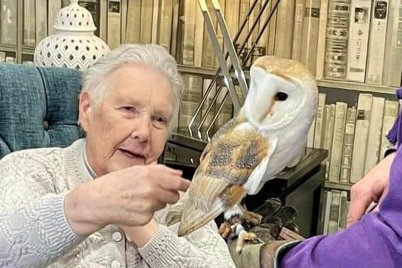 Resident Jane is thrilled to stroke Cosmic the owl.