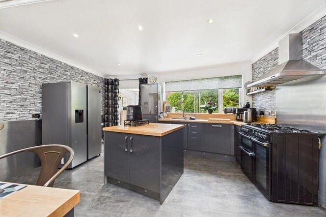 The modern, open plan kitchen has a Rangemaster style oven.