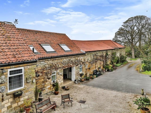 A private road leads up to the cottage in the grounds of 19th century hunting lodge Throxenby Hall.