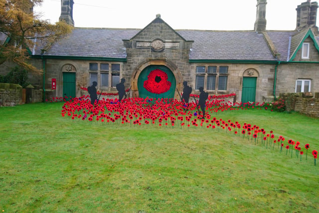 Brenda Legg has created this knitted poppy display at Roxby, near Staithes.