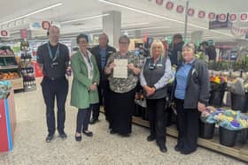 Andrea Hansell and Samantha Buckle from WHISH, accepting a cheque from Co-op Deputy Manager Steve Danby, and Co-op staff.