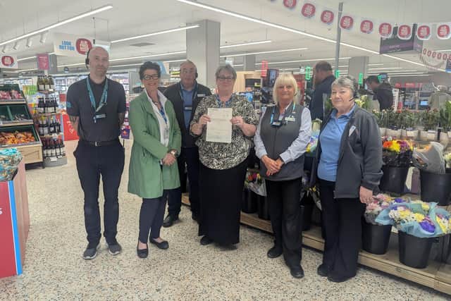 Andrea Hansell and Samantha Buckle from WHISH, accepting a cheque from Co-op Deputy Manager Steve Danby, and Co-op staff.