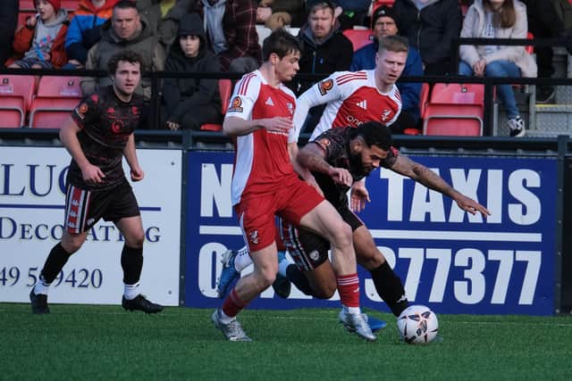 Sam Reed and Alex Wiles close in on a Hereford player.