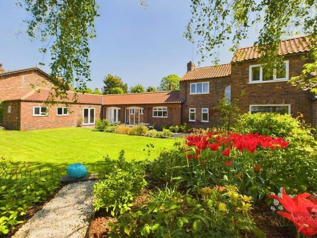 The property has large and established gardens with mature trees.