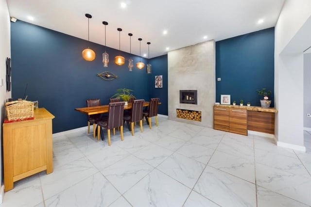 The dining area linked to the kitchen has a feature woodburner.