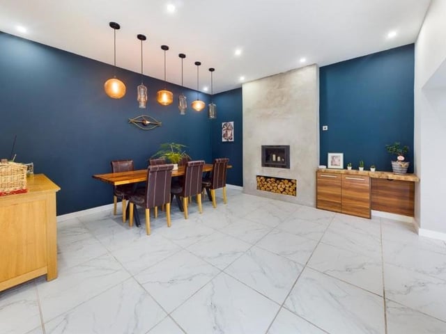 The dining area linked to the kitchen has a feature woodburner.