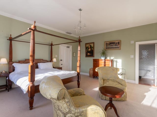 One of the spacious bedrooms within the house.