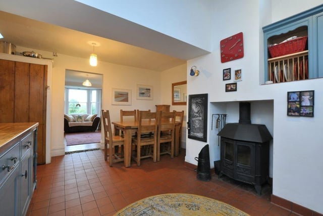 The kitchen with diner has a warming wood burning stove within an inglenook fireplace as one of its features.