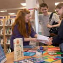 Outreach librarian Claire Thompson, left, shares North Yorkshire Libraries’ free Self-Care Toolkit with interested teenagers.