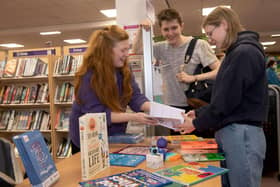 Outreach librarian Claire Thompson, left, shares North Yorkshire Libraries’ free Self-Care Toolkit with interested teenagers.