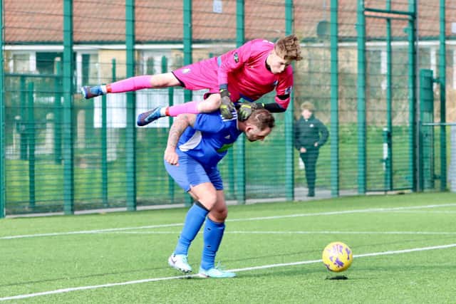 The Rovers keeper fouls a Colts player to concede a penalty.