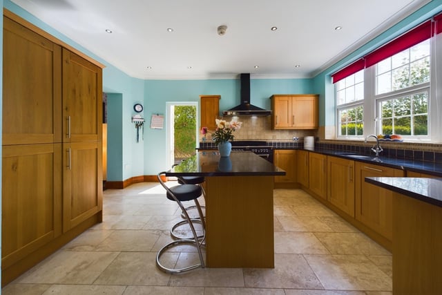 A lovely large breakfast kitchen has oak units and a Rangemaster stove.