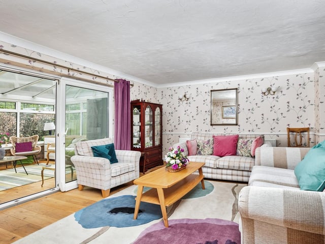 A bright and pleasant living room leads through tot he conservatory.