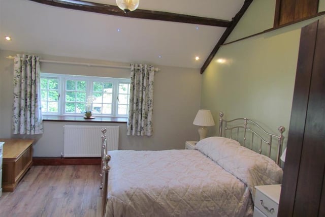 The light and spacious, beamed double bedroom on the first floor of the cottage.
