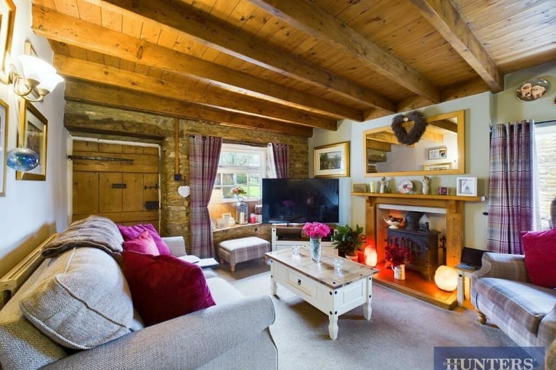 An alternative view of the lounge, with its cosy log burner.