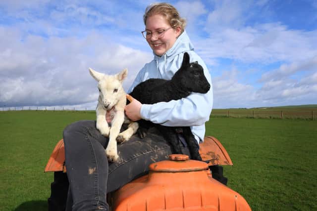 Farmer Megan Wilson with newly born twin lambs Ebony and Ivory