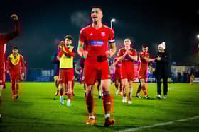 Boro skipper and goal-scoring hero Will Thornton, centre, leads the celebrations and thanks to the away fans at Curzon Ashton. PHOTO BY CHRIS MARSON