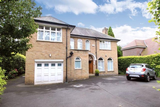 The front of the property has a large driveway.