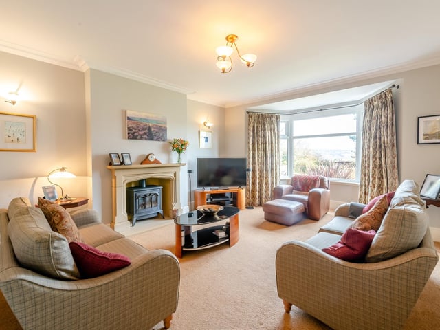 A bay-fronted sitting room with feature fireplace.