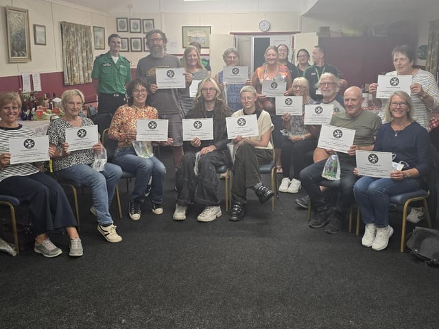 The villagers proudly show off their new ‘first aid competent first aid certificate’ with the trainers