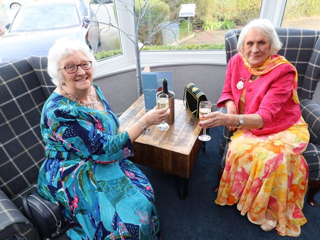 Guests raise their glasses to celebrate the occasion