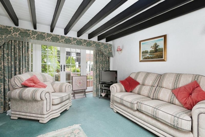 An interior with comfort and character. Ground floor rooms feature French doors to the garden and patio.