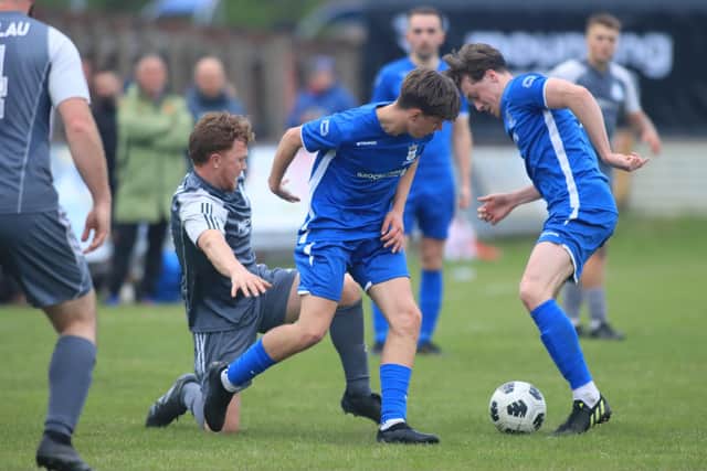 Bridlington Rovers Millau (grey kit) battle it out with North Cave in the East Riding FA Senior Country Cup final at Queensgate. Photo by TCF Photography