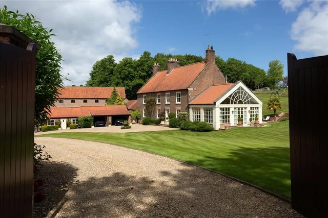 This six bedroom, four bathroom and six reception room detached house is currently for sale with Savills for offers over £1,795,000.