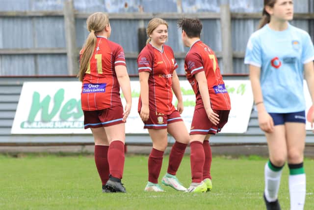 A trio of home players celebrate a goal during their comfortable win against Beverley.