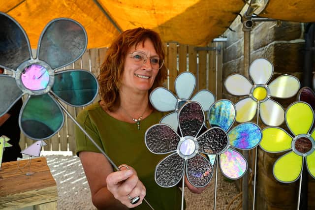 Stained glass artist Janet Fraser with some of her work for sale. photo: Richard Ponter