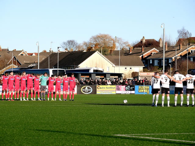 Both sets of players and fans observe a minute’s silence to remember Boro supporters John Leppington and David Hayward.