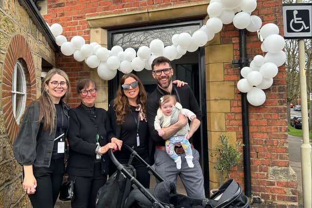 Sam with his family at the opening