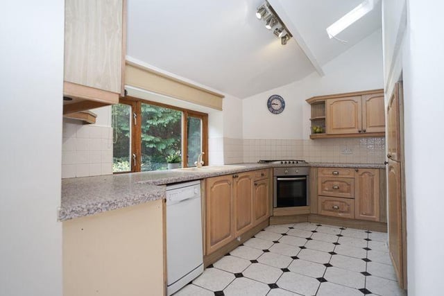 The kitchen with fitted units and garden views.