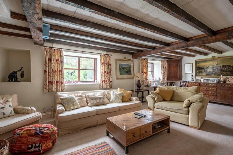 A spacious reception room with beams to the ceiling.