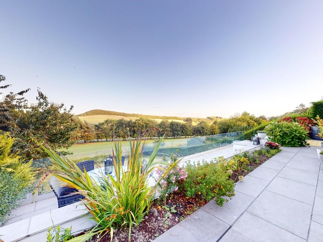 Patio areas are perfect for al fresco dining, with one currently used to house a hot tub.