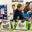 Home library service volunteers, Jennie Leitch (left) and Annabel Garnett, looking through the resources included in the wellbeing bags.