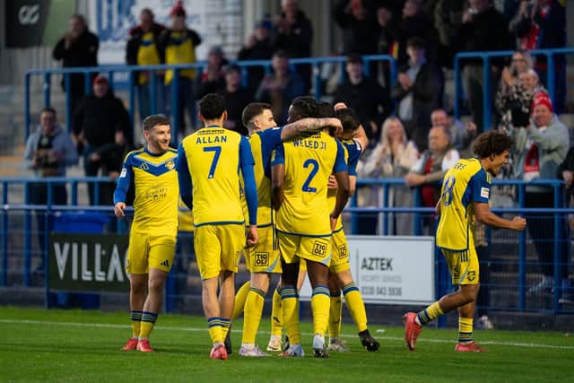 Boro players celebrate with goalscorer Kieran Weledji after he made it 2-0 at Curzon Ashton. Photo by Wandering Photography