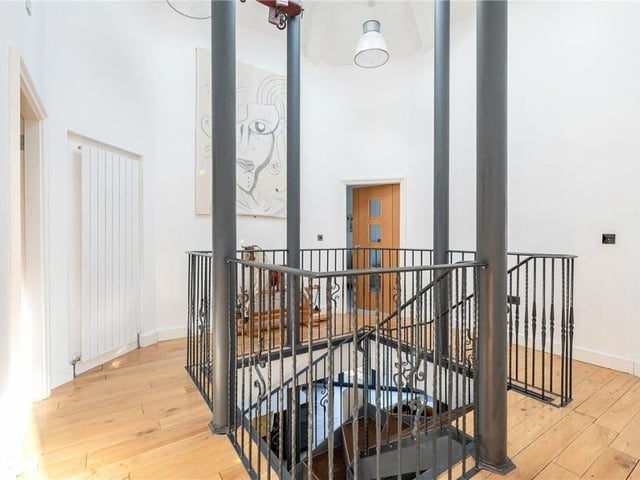 The first floor landing has natural light from a large skylight placed above the staircase.