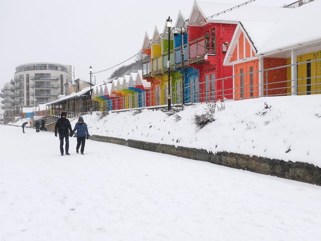 The colours of the beach hits stand out against the snowy backdrop. photo: Richard Ponter